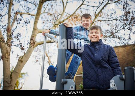 Two happy boys on the schoolyard playground during break time Stock Photo