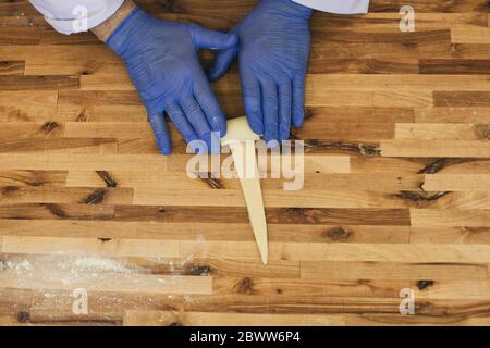 A hand of a chef roll french bread croissant Stock Photo