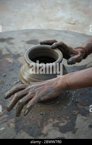 Hands working on pottery wheel and making a pot Stock Photo