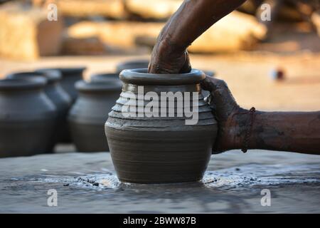 Hands working on pottery wheel and making a pot Stock Photo