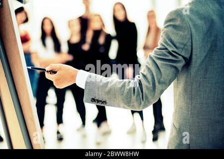 close up. businessman pointing with pen on a flipchart Stock Photo