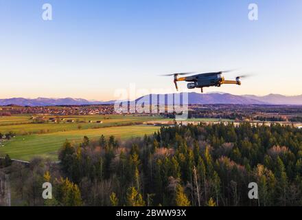 Germany, Bavaria, Konigsdorf, Drone flying over rural grove at dusk Stock Photo