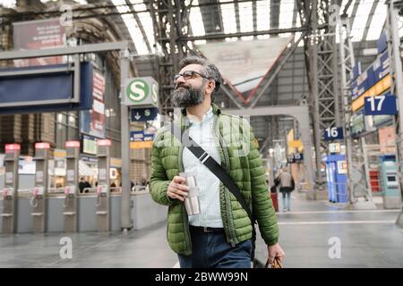 Man walking at the train station Stock Photo