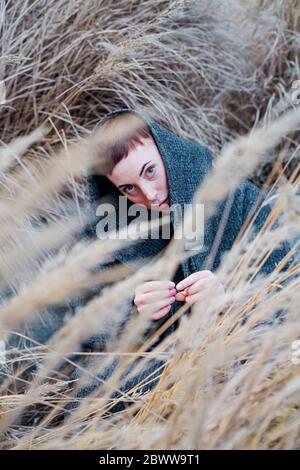Portrait of young woman among grasses Stock Photo