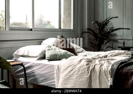 Unmade bed in a loft Stock Photo