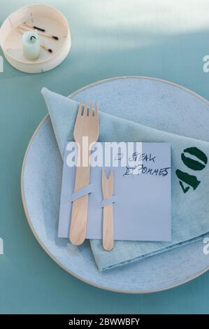 Germany, Plate, cloth napkin and DIY menu with wooden forks Stock Photo