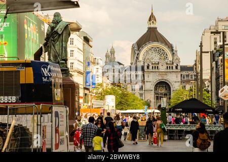 Antwerp, Flanders, Belgium. August 2019. Old town: in the background the imposing railway station. The course leading to it is crowded with people who Stock Photo