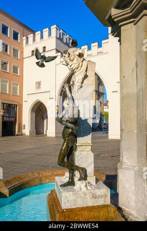 Germany, Bavaria, Munich, Brunnenbuberl fountain with Karlstor gate in background Stock Photo