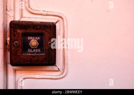 Close up Vintage Fire alarm on Concrete Wall. Stock Photo