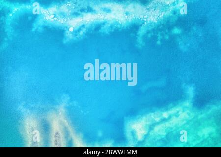 Clear turquoise colored shallow water surface with bottom visible. Aerial top view for texture and background Stock Photo