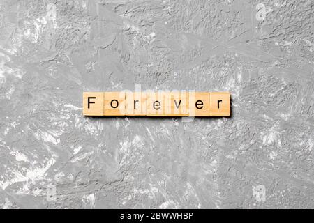 forever word written on wood block. forever text on table, concept. Stock Photo