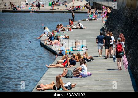 People enjoy the sun at Clevedon Marine Lake  after Coronavirus lockdown restrictions were eased in England. Stock Photo