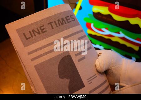 SEOUL, SOUTH KOREA - DECEMBER 24, 2018:  Line Times Newspaper in James Hand who A young guy character is a famous LINE friends character. It's launche Stock Photo