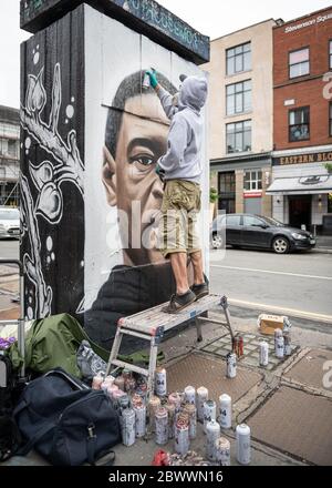 Manchester, UK. 03rd June, 2020. Street artist, Akse P19, puts the finishing touches to his mural of George Floyd. Credit: SOPA Images Limited/Alamy Live News Stock Photo