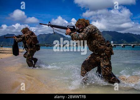 U.S. Marines with with Lima Company, 3rd Battalion, come ashore during an amphibious assault exercise, on the Mokapu Peninsula May 28, 2020 in O'ahu, Hawaii, USA. Stock Photo