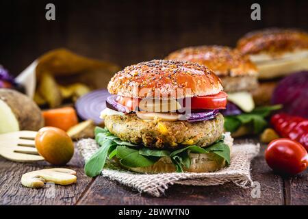 vegan food, meatless sandwich or elements of animal origin. Bread without eggs or milk, with vegetable and fiber or soy burger, on a rustic table. Veg Stock Photo