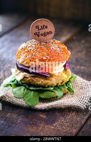 vegan food, meatless sandwich or elements of animal origin. Bread without eggs or milk, with vegetable and fiber or soy burger, on a rustic table. Veg Stock Photo