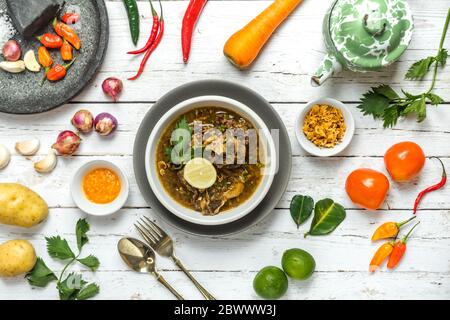 Oxtail soup and fried oxtail are served on the table side by side with the basic spices. Stock Photo