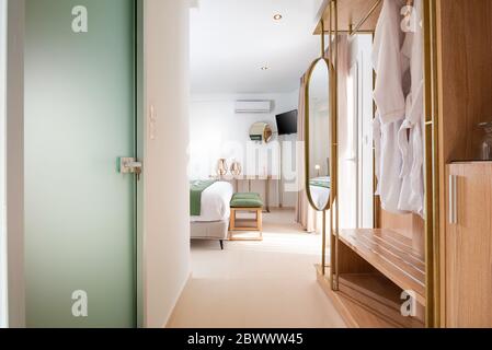 Apartment entrance hallway with bathroom glass door and wooden wardrobe cabinet. front view of modern spa hotel interior room Stock Photo