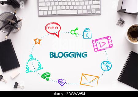 Word BLOGGING and web icons on office desk with gadgets and stationery, white background. Flat lay. Collage Stock Photo