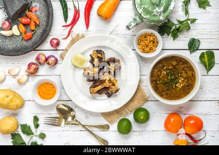 Oxtail soup and fried oxtail are served on the table side by side with the basic spices. Stock Photo