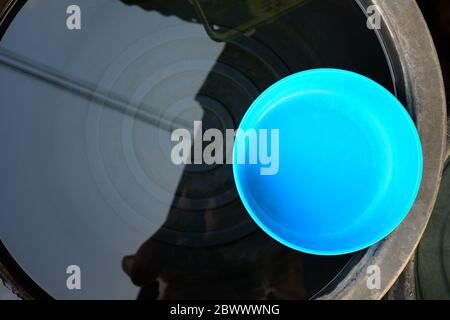 Blue Plastic Bowl in Black Basin. Stock Photo
