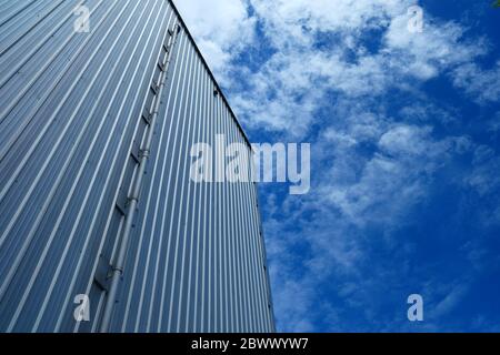 Warehouse Wall with Blue Sky Background. Stock Photo