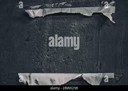 Torn Paper on Concrete Wall in the Dark Tone. Stock Photo