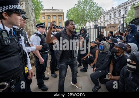 Black Lives Matter (BLM) activists and supporters angrily confront police in Westminster following the death of George Floyd, a black man, who died in police custody on 25th May in Minneapolis. London, UK. Stock Photo