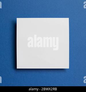 White memo pad, empty paper on dark blue background. top view, copy space Stock Photo