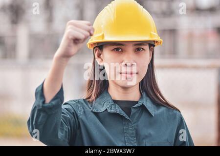 Asian Woman Engineering Yellow helmet hard hat safety Stock Photo