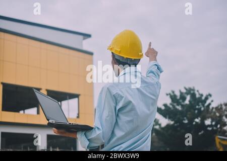 Project Engineering construction use computer notebook working on site management Stock Photo