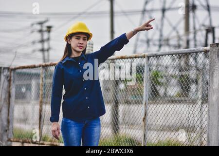 Engineering standing outdoors inspection on site power plant electrical Stock Photo