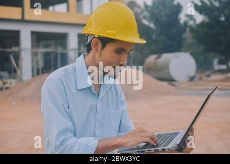 Project Engineering construction use computer notebook working on site management Stock Photo