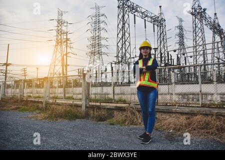 Women Engineering standing communication at power plant  electrical system background Stock Photo