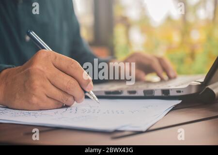 Close up  Hand writing on paper work,People signature on document,Man drawing on paper Stock Photo