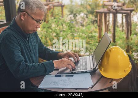 Engineering using computer working check building construction by internet technology Stock Photo
