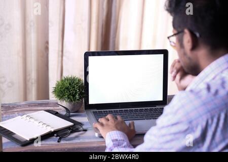 Back view of businessman working on laptop. Stock Photo
