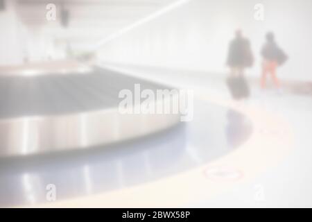 White Blurred Passengers Walking in Luggage Conveyor Belt Zone of the Airport. Stock Photo