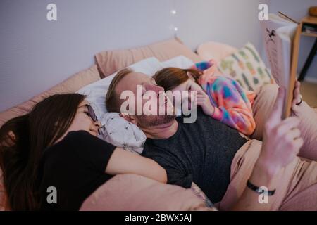 close up portrait of father reading to his daughters Stock Photo