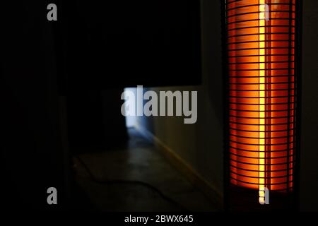 Portable Heater in the Dark Room with Space for Text. Stock Photo