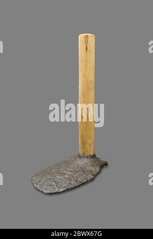 Montilla, Spain - March 2nd, 2019: Roman hoe. Agricultural iron tool with replica wooden handle and original narrow head. Isolated. Montilla Local His Stock Photo