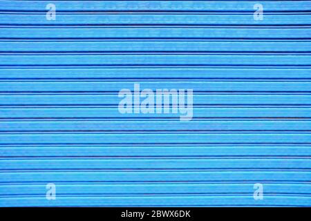 Old Blue Painting on Foldable Metal Door Background. Stock Photo
