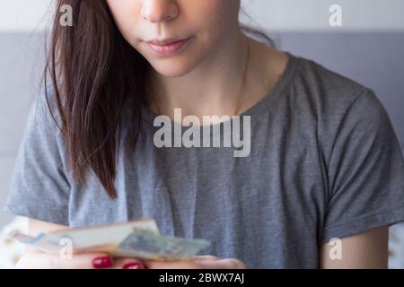 Woman holding euro money in her hands. Economy and financial crisis. Saved money. Financial turmoil crisis. Lack of money. Unemployment. Unemployed Stock Photo