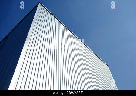 Warehouse Wall with Blue Sky Background. Stock Photo
