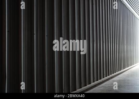 Corrugated Metal Wall with Light Leak from the Hallway. Stock Photo