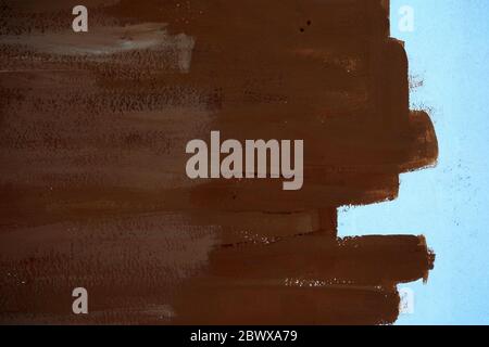 Brown Brush Stroke Painting on White Concrete Wall Texture Background. Stock Photo