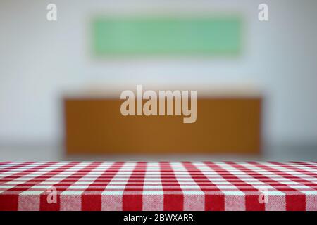 Empty Table Covered with Red Checkered Tablecloth and Blurred Art Gallery Hallway Background. Stock Photo