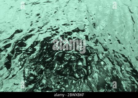 Water Wave Surface Texture Background in Neo Mint Color Tone. Stock Photo