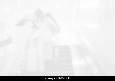 Blurred Travellers Standing on Subway Escalator. Stock Photo